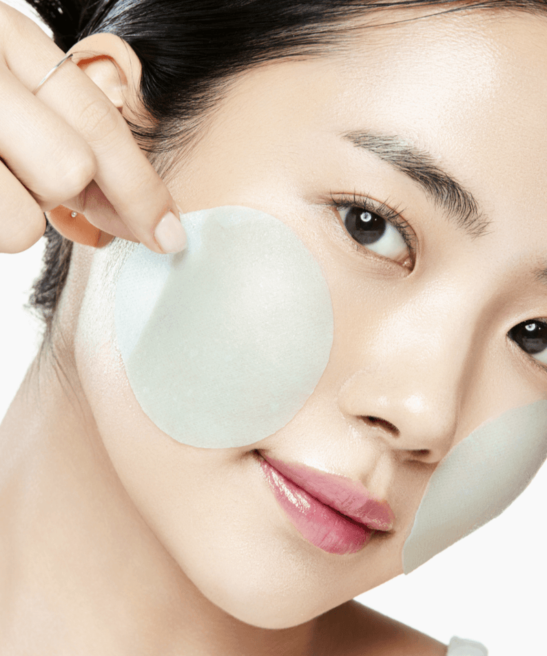 ANUA PDRN 100 Hyaluronic Acid Glow Pad applied on woman's cheek for skincare