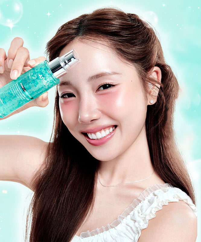 Smiling person holding ANUA PDRN Hyaluronic Acid Moisture Capsule Mist 100ml against a light turquoise background.