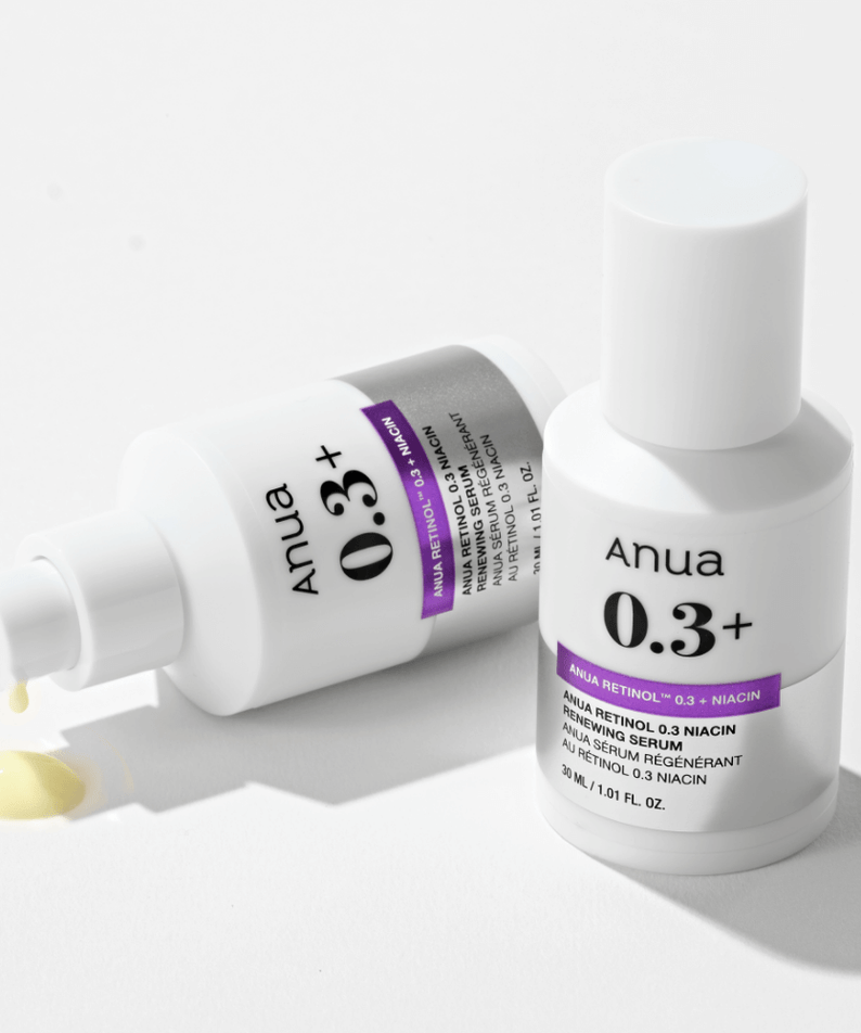 ANUA Retinol 0.3 Niacin Renewing Serum bottles with pump and spilled serum in white background