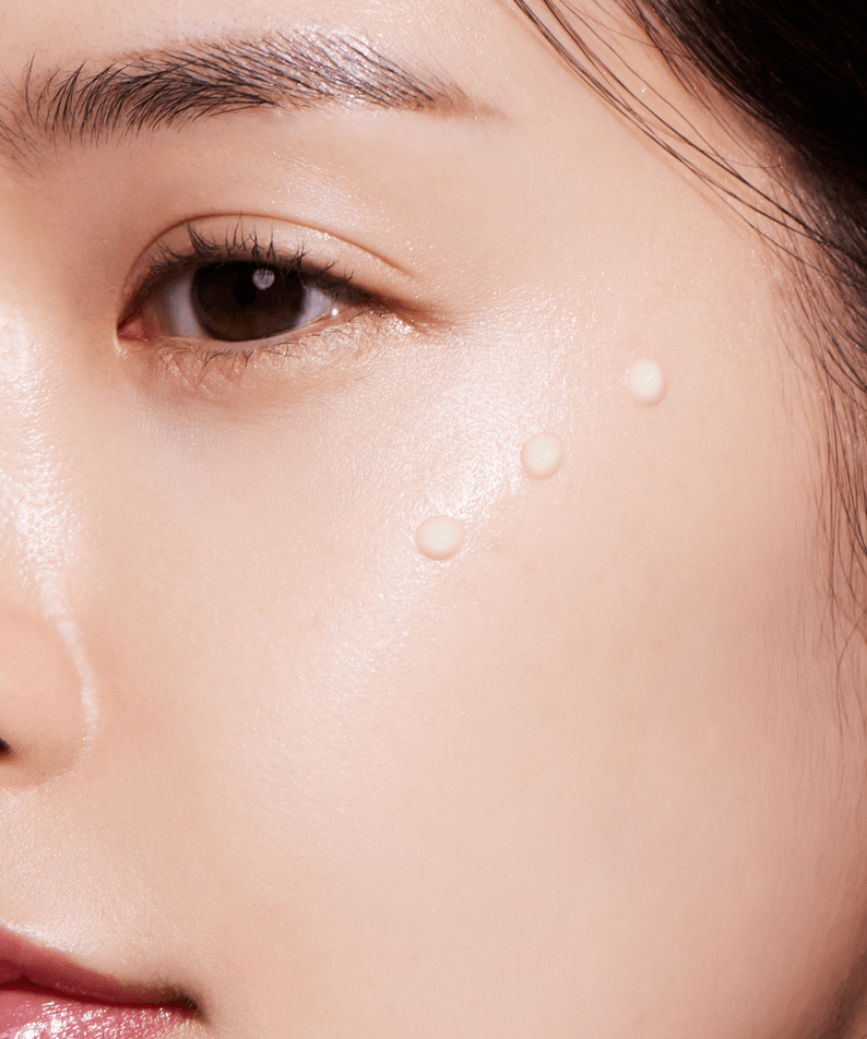 Close-up of a face applying ANUA Retinol 0.3 Niacin Renewing Serum on the cheek for skincare routine.