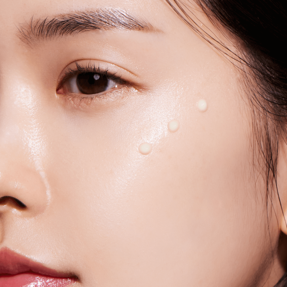 Close-up of a face applying ANUA Retinol 0.3 Niacin Renewing Serum on the cheek for skincare routine.