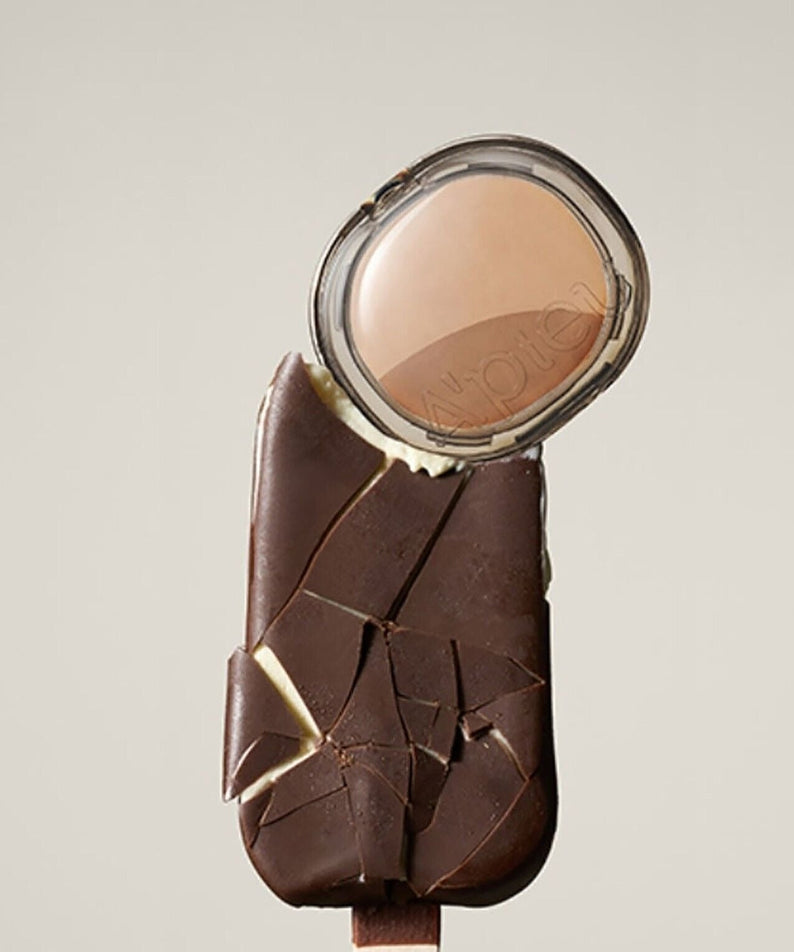 A'PIEU Juicy Pang Layering Shading next to chocolate ice cream bar, showcasing the product's packaging and color.