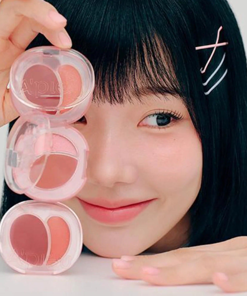Person showcasing A'PIEU Juicy Pang Mood Blending Lip & Cheek Balm in a playful arrangement.