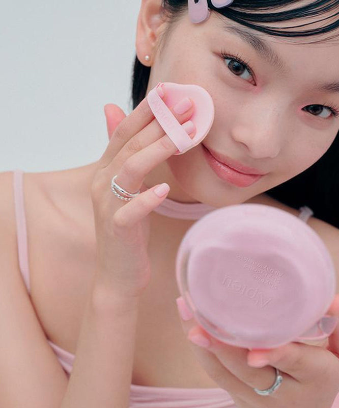 Person applying A'PIEU Waterlock Comfort Veil Cushion 15g with a puff on face.
