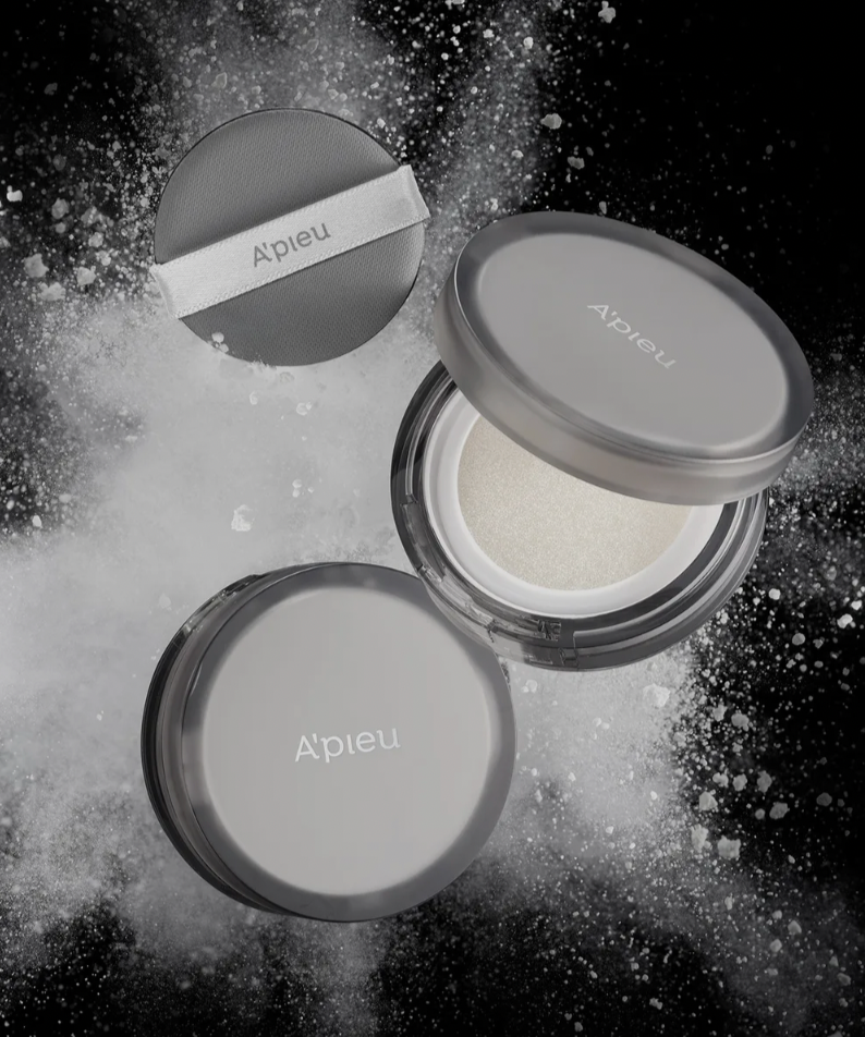 A'PIEU Waterlock Finisher Super Velvet compact powder against a dramatic black background with powder explosion effect.