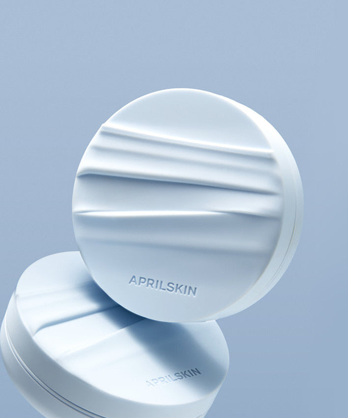 APRIL SKIN Glowing Matt Cushion on a reflective surface with textured design.