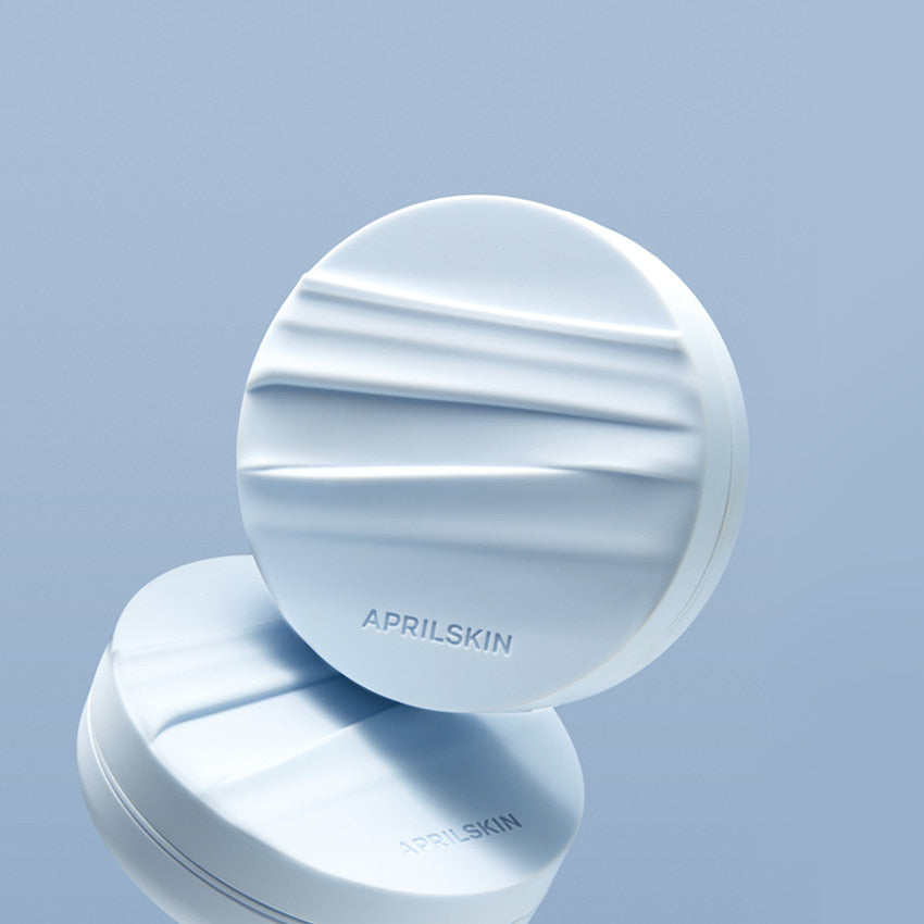 APRIL SKIN Glowing Matt Cushion on a reflective surface with textured design.