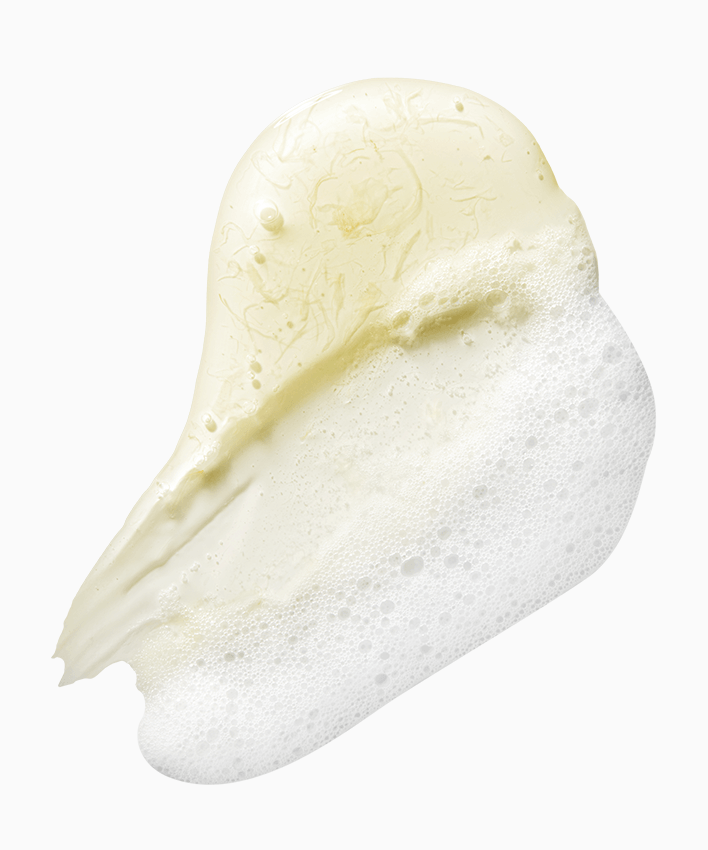 Texture of APRILSKIN Calendula Low PH Foam Cleanser showing creamy, foamy lather on white background.
