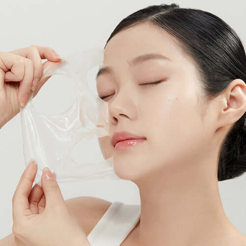 Woman using APRILSKIN Calendula Peel Off Pack for skincare