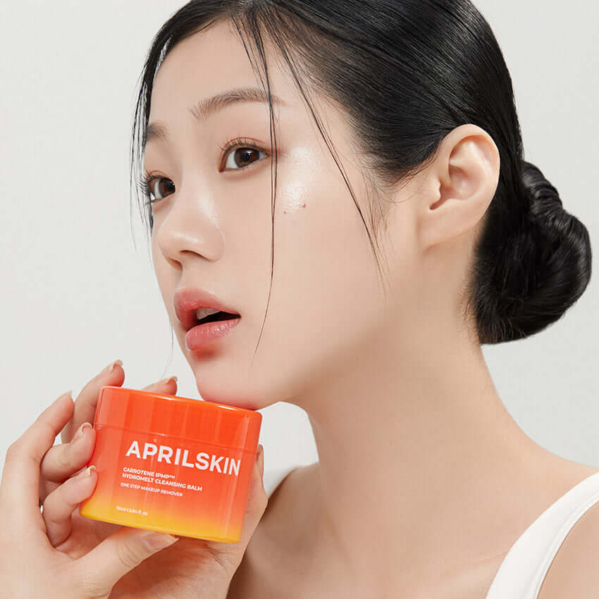 Woman holding APRILSKIN Carotene Melting Cleansing Balm