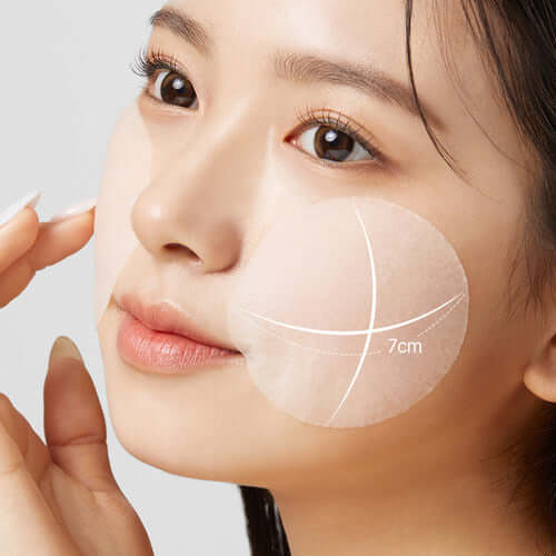 Close-up of a woman using APRILSKIN Carrotene IPMP Inatant Calming Serum Pad on her face