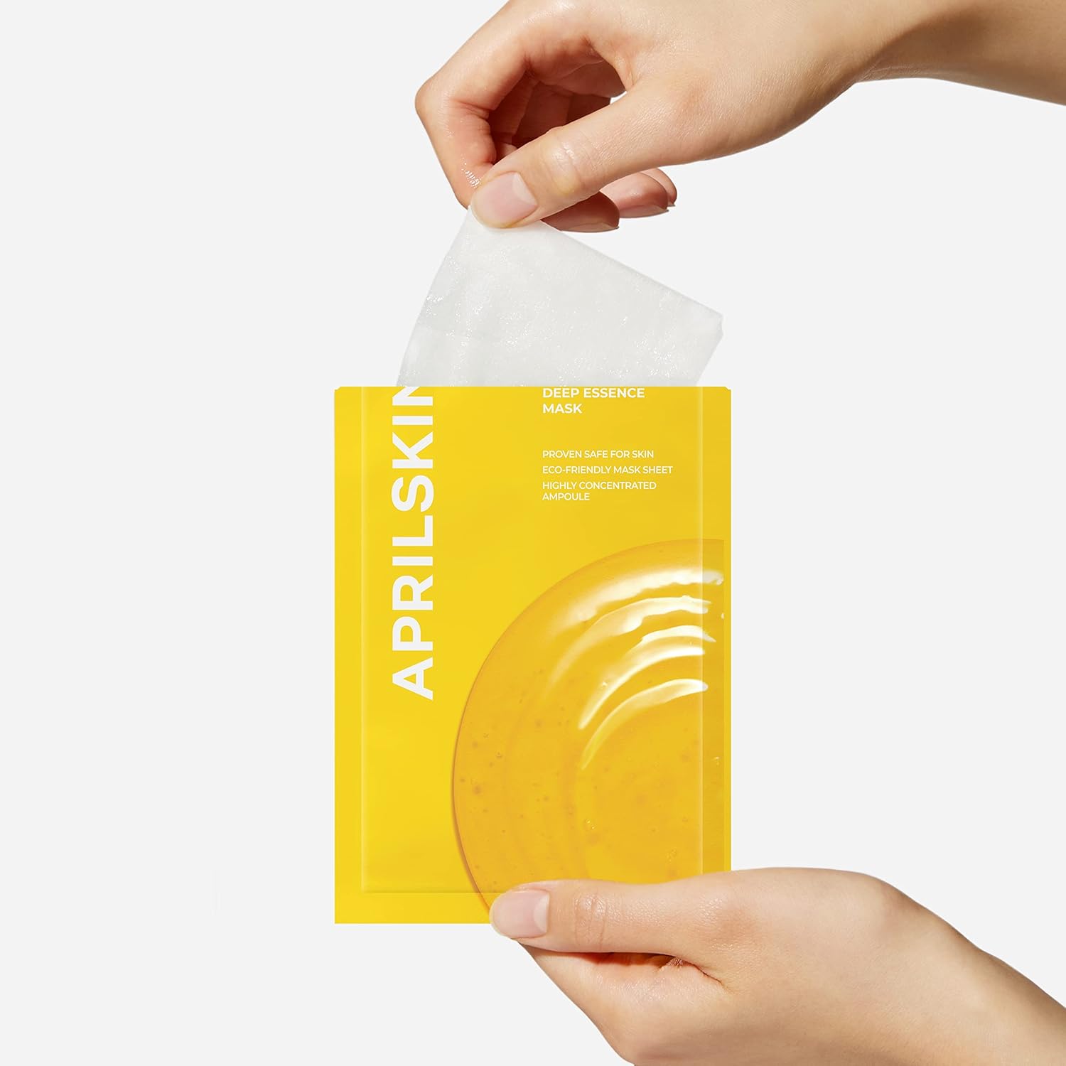 Hand holding APRILSKIN Real Calendula Deep Essence Mask in yellow packaging