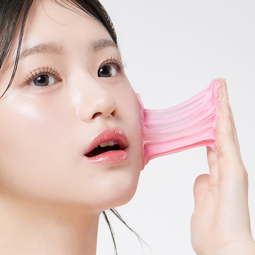 Woman using a stretchy facial cleanser mask, showcasing skincare routine with APRILSKIN TXA Niacinamide 99 Deep Cleanser 120g.