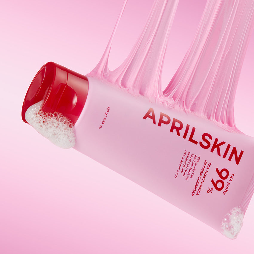 APRILSKIN TXA Niacinamide 99 Deep Cleanser 120g product packaging with foamy texture and pink background.