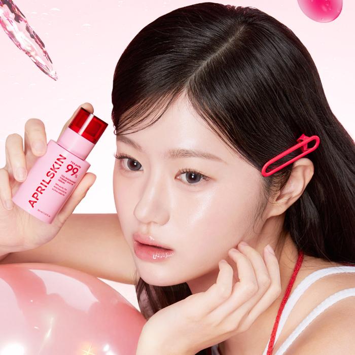 Model holding APRILSKIN TXA Niacinamide Toning Shot 99 Serum 30ml bottle