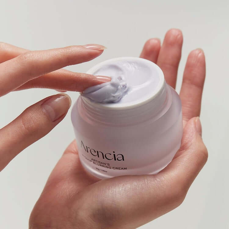 Woman applying ARENCIA Artisan Hysop Blurring Cream 30g to skin from jar
