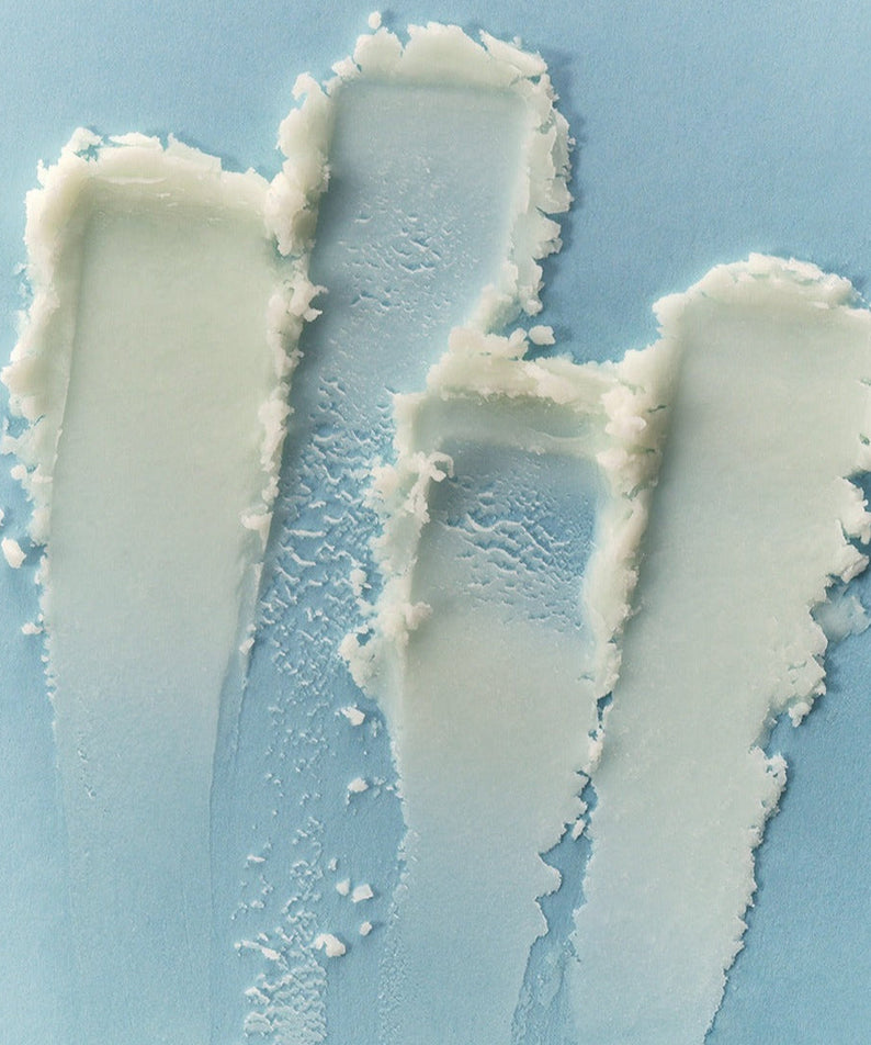 Texture of ARENCIA Cloud Sun Stick 18g showing smooth application on a blue background.