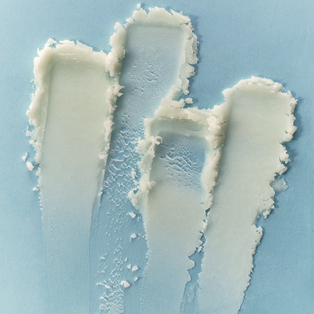 Texture of ARENCIA Cloud Sun Stick 18g showing smooth application on a blue background.
