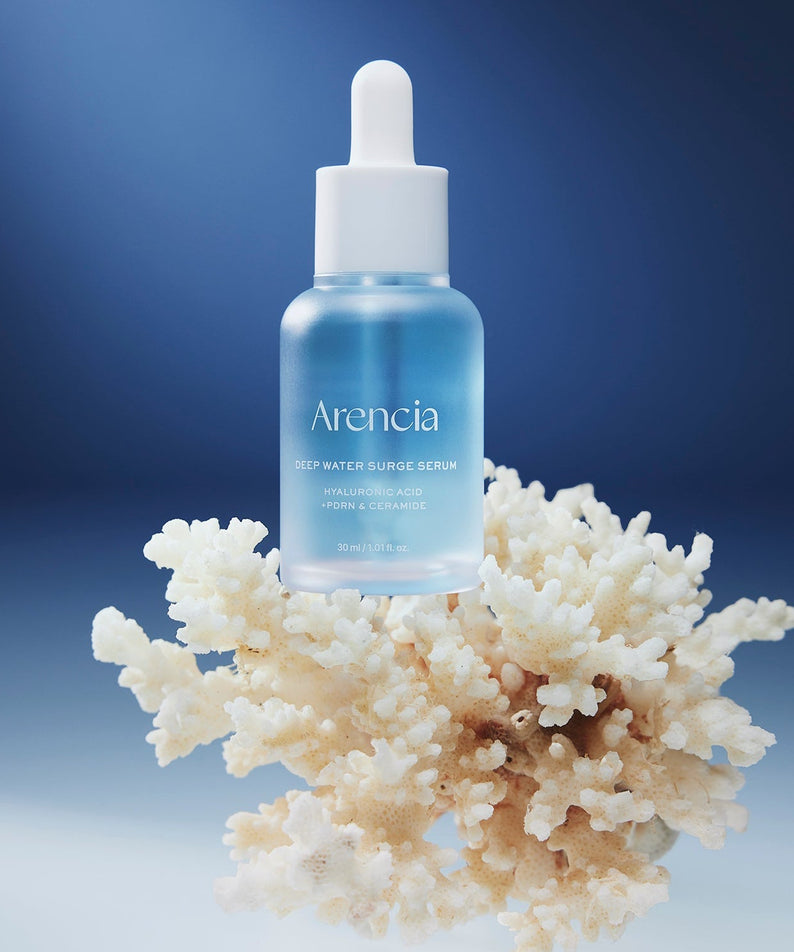 ARENCIA Deep Water Surge Serum 30ml bottle displayed on coral background