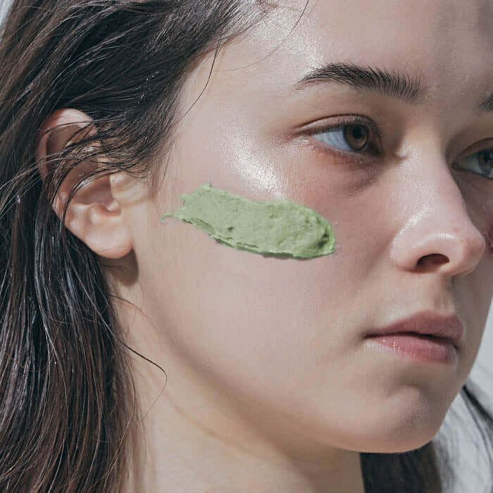 Model applying ARENCIA Green Artisan Cleanser Rice Soap 120g on face for skincare.