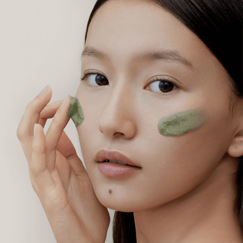 Woman applying ARENCIA Green Tea + LHA Deep Pore Rice Cake Soap 150ml on face