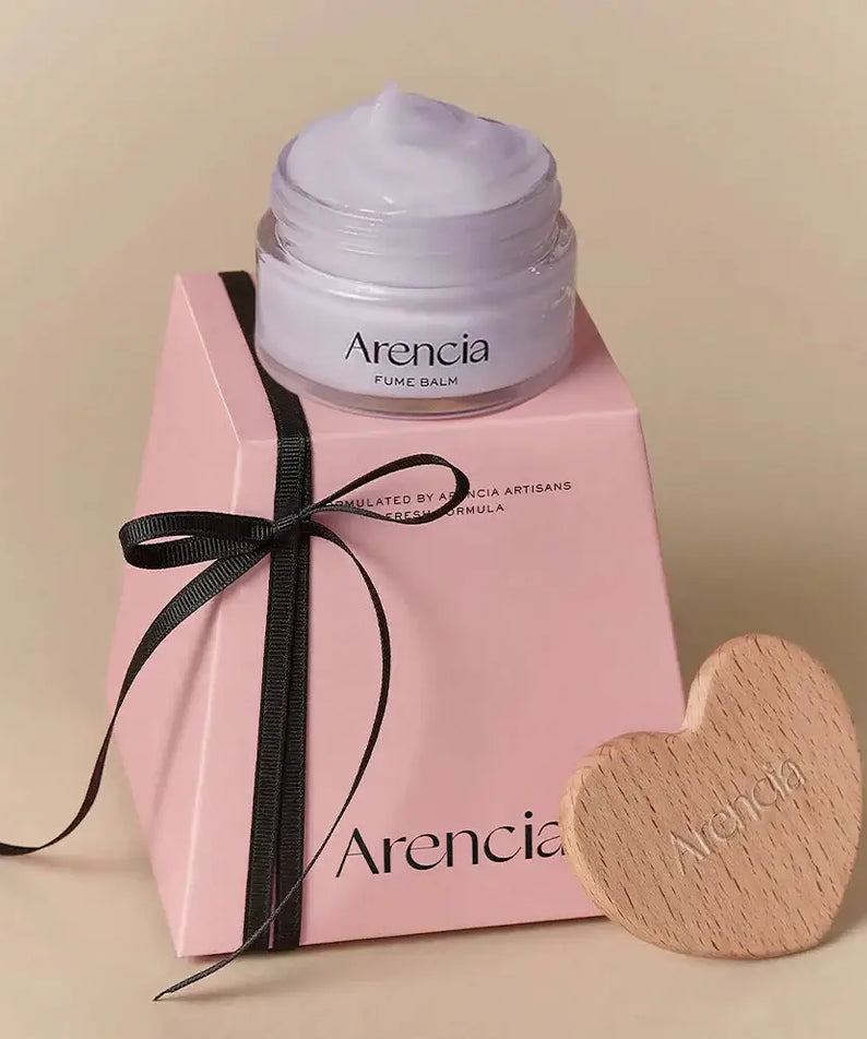 ARENCIA Hyssop Fume Balm 30g beautifully packaged with a wooden heart accessory. Skincare product in elegant presentation.