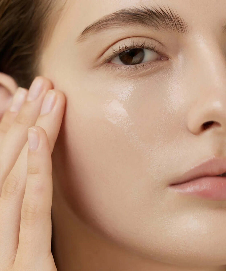 Application of ARENCIA Rice Mucin Glow Serum 30ml on woman's face for enhanced glow