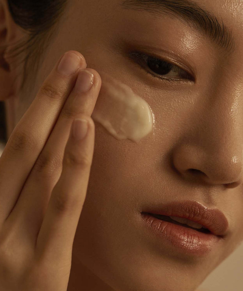 Model applying AROMATICA Glow Vita Good Night Cream Orange & Neroli 90G to face