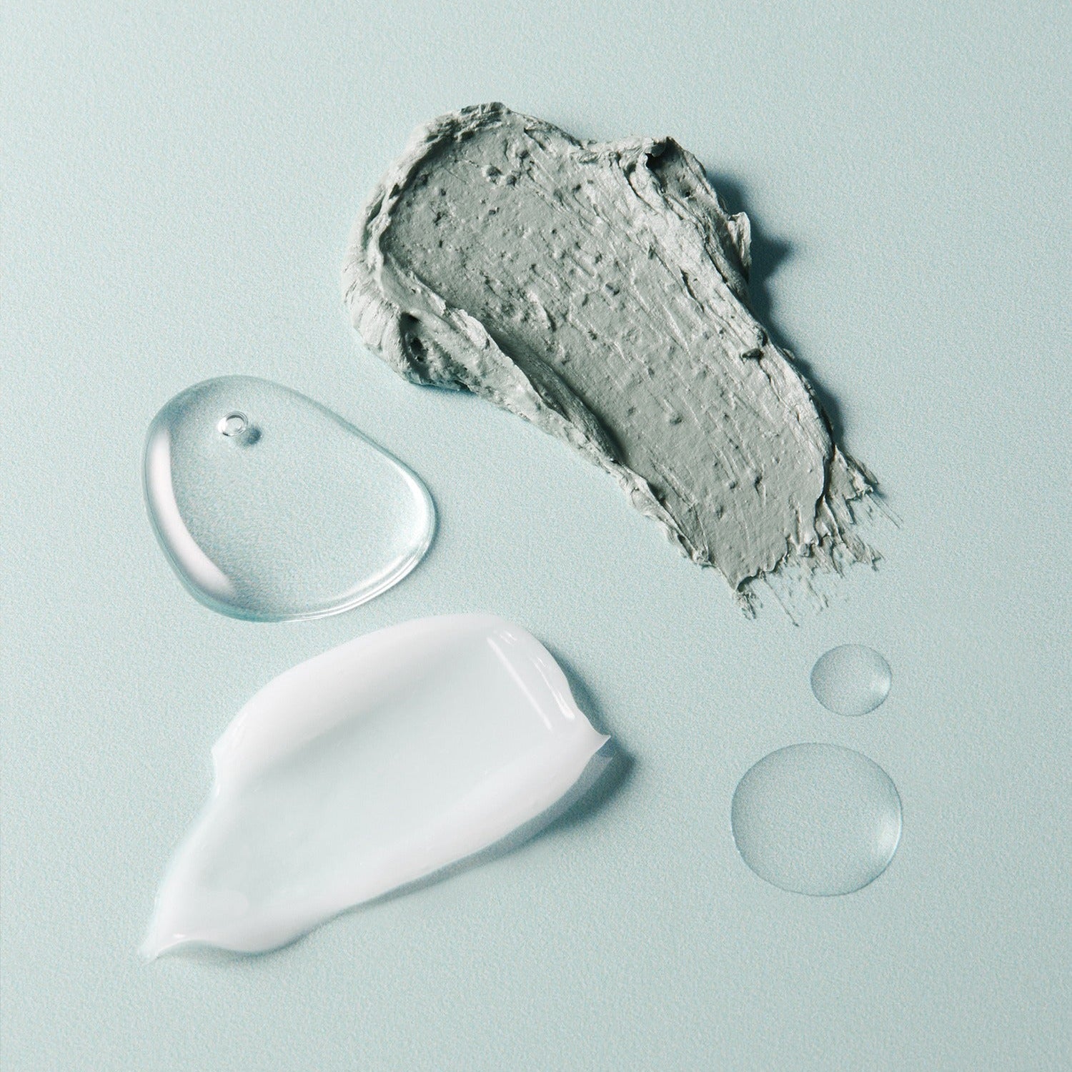 Textures of the AROMATICA Super Tea Tree Clay Mask Cleanser 150ML showing clay and liquid elements on a pastel background