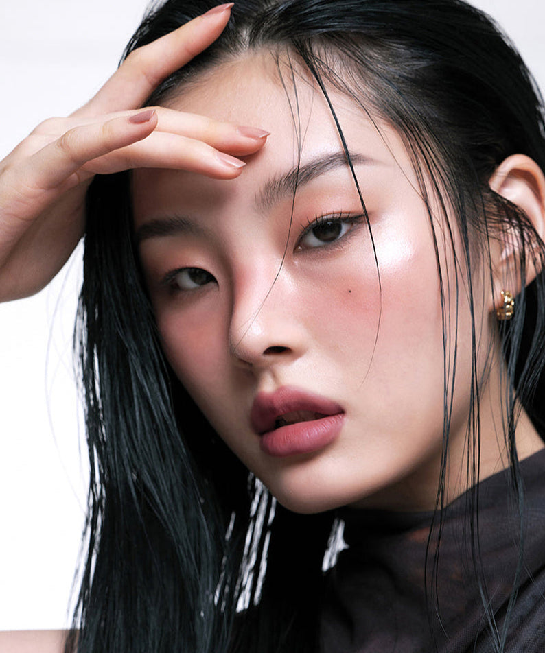 Model wearing ARTESINSA Silky Blur Tints showcasing makeup look with glowing skin and sleek hair style.