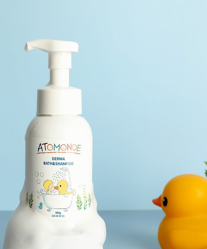 ATOMANDE Derma Bath & Shampoo Bubble Cleanser Foam Type 300g bottle with rubber duck on blue background.