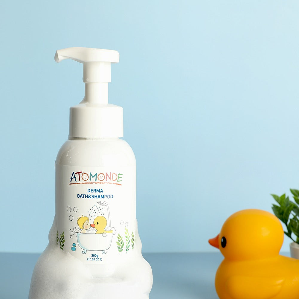 ATOMANDE Derma Bath & Shampoo Bubble Cleanser Foam Type 300g bottle with rubber duck on blue background.