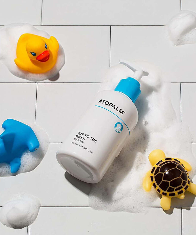 ATOPALM Atopalm Top to Toe Wash 460ml + Refill 400ml Set with foam and bath toys on a tiled surface