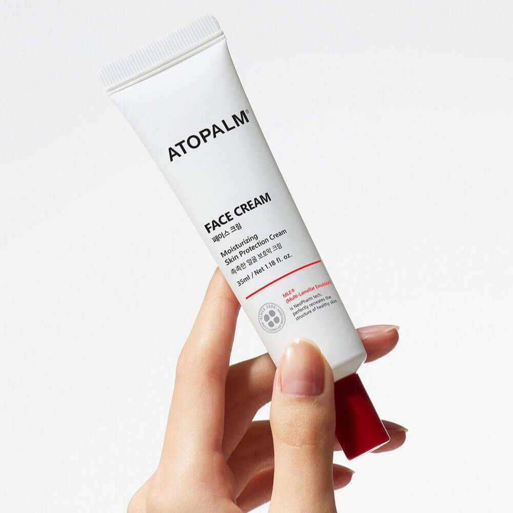 ATOPALM Face Cream 35ml tube held in hand, ideal for moisturizing and soothing skin.