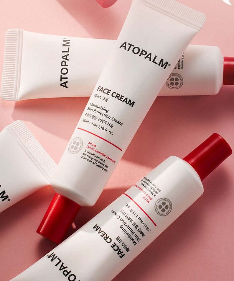 ATOPALM Face Cream 35ml in white tubes with red caps on a pink background