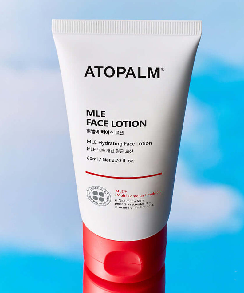 ATOPALM Face Lotion 80ml tube against sky background.