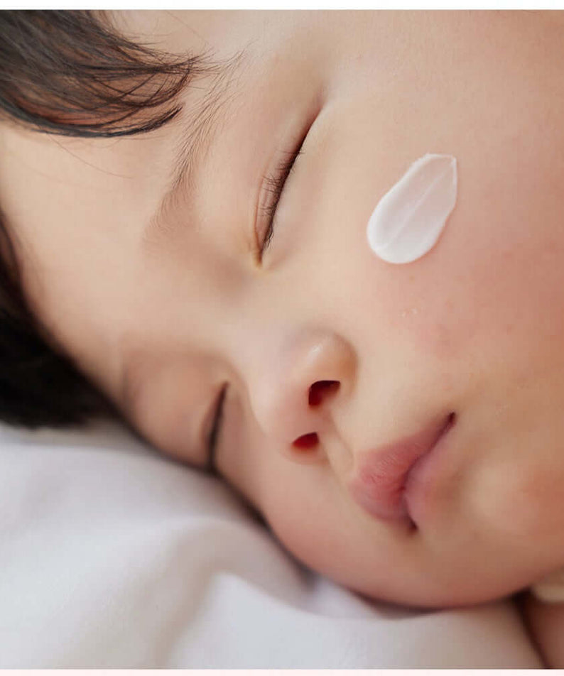 Close-up of a sleeping child with ATOPALM Face Lotion 80ml applied to the cheek for soothing skin care.