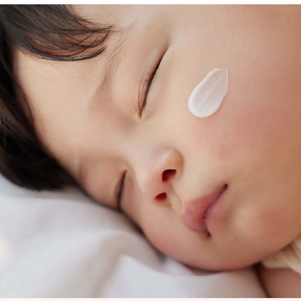 Close-up of a sleeping child with ATOPALM Face Lotion 80ml applied to the cheek for soothing skin care.