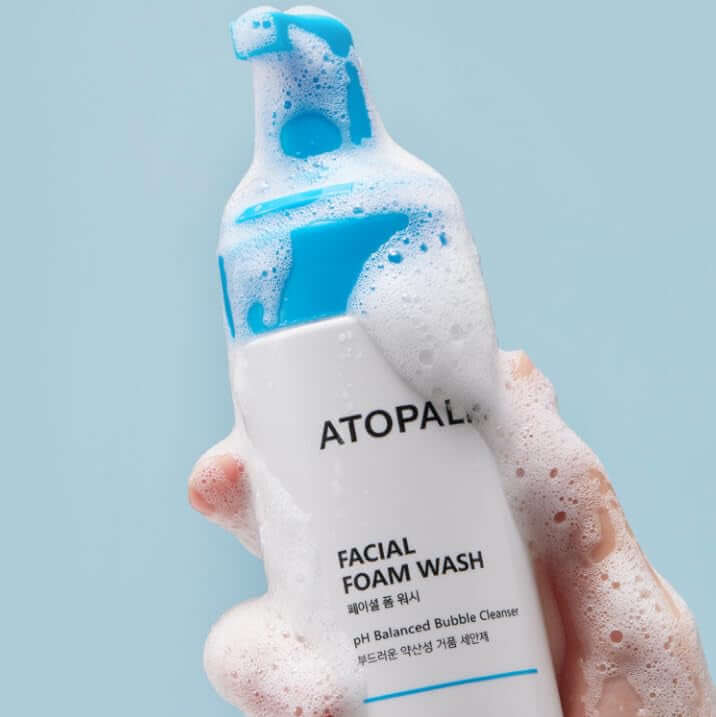 ATOPALM Facial Foam Wash 150ml bottle with foamy lather in hand against blue background