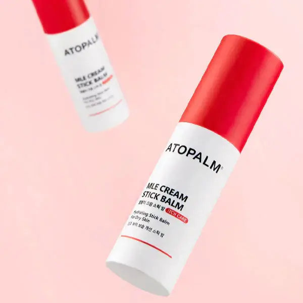 ATOPALM MLE Cream Stick Balm 10g product image with red and white packaging on a pink background.