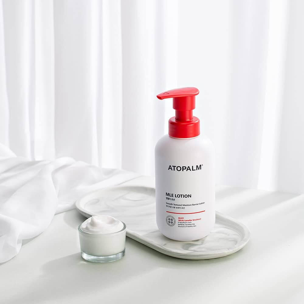 ATOPALM MLE Lotion 300ml bottle on a tray with a small jar of cream