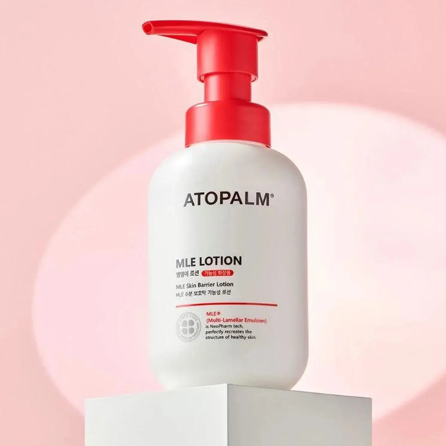 ATOPALM MLE Lotion 300ml on display with pink background.