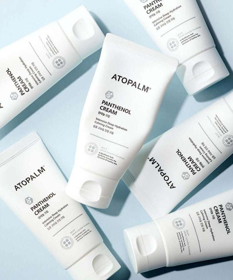 ATOPALM Panthenol Cream 80ml tubes arranged on a blue surface