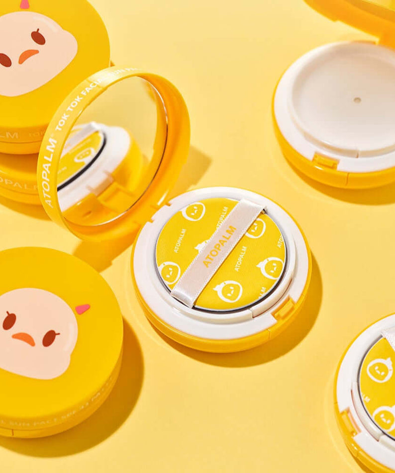 ATOPALM Toktok Facial Sun Pact SPF43 PA+++ 15g compact on yellow background with cushion and mirror