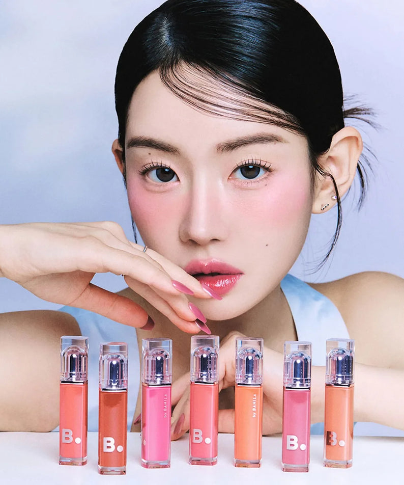 Model showcasing BANILA CO Dew Glow Tint in a variety of vibrant shades, highlighting the product's sleek packaging and color options.