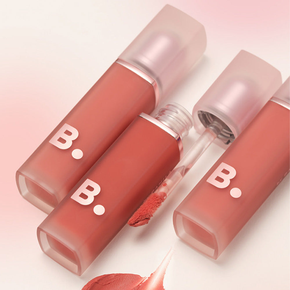 BANILA CO New Sheer Velvet Veil Tint bottles open with applicators visible on a pink background.