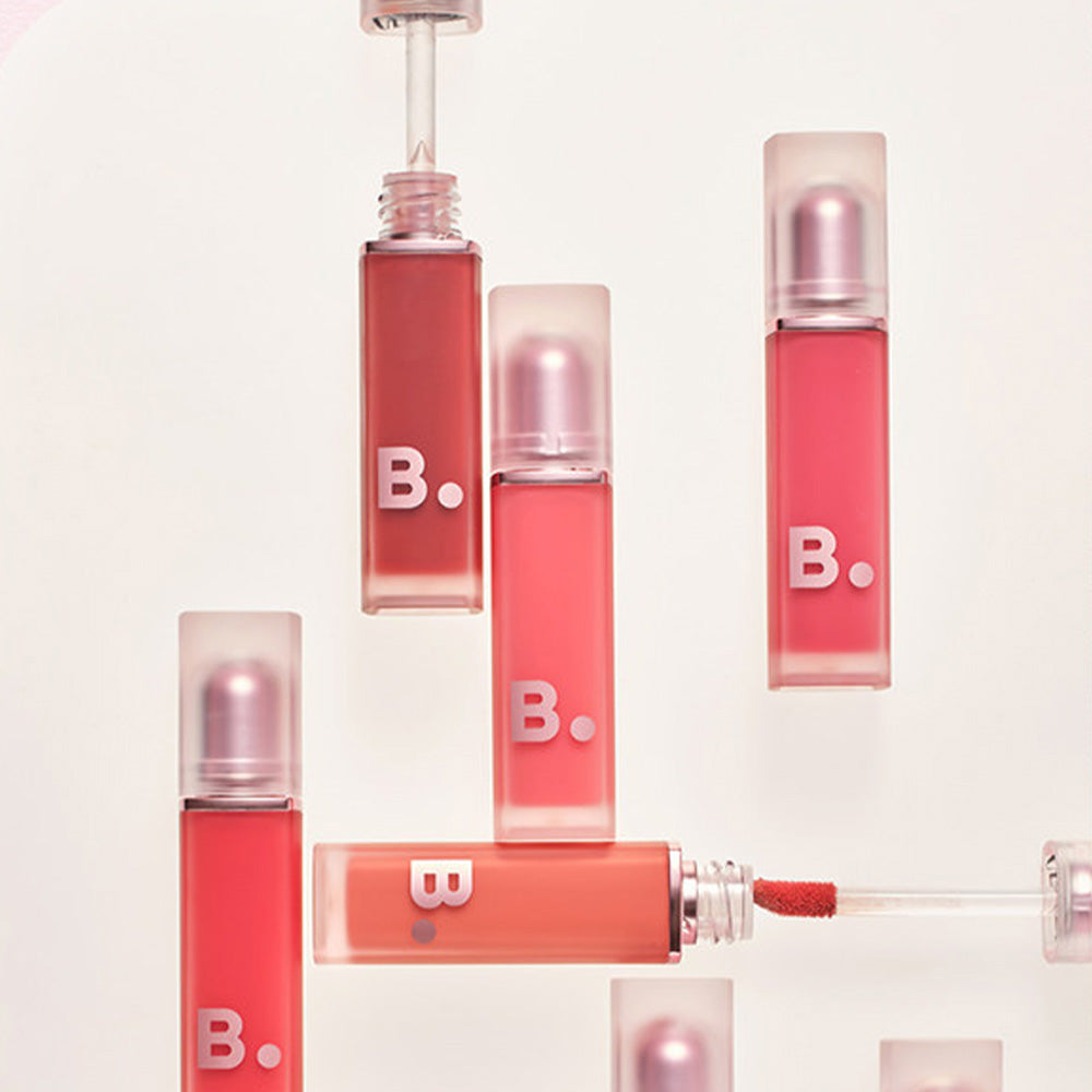 Assorted shades of BANILA CO New Sheer Velvet Veil Tint lipsticks.