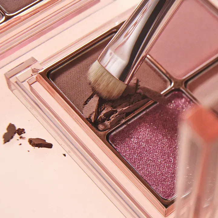 BANILACO Mood On Eye Palette with makeup brush applying eyeshadow, featuring shimmering and matte shades.