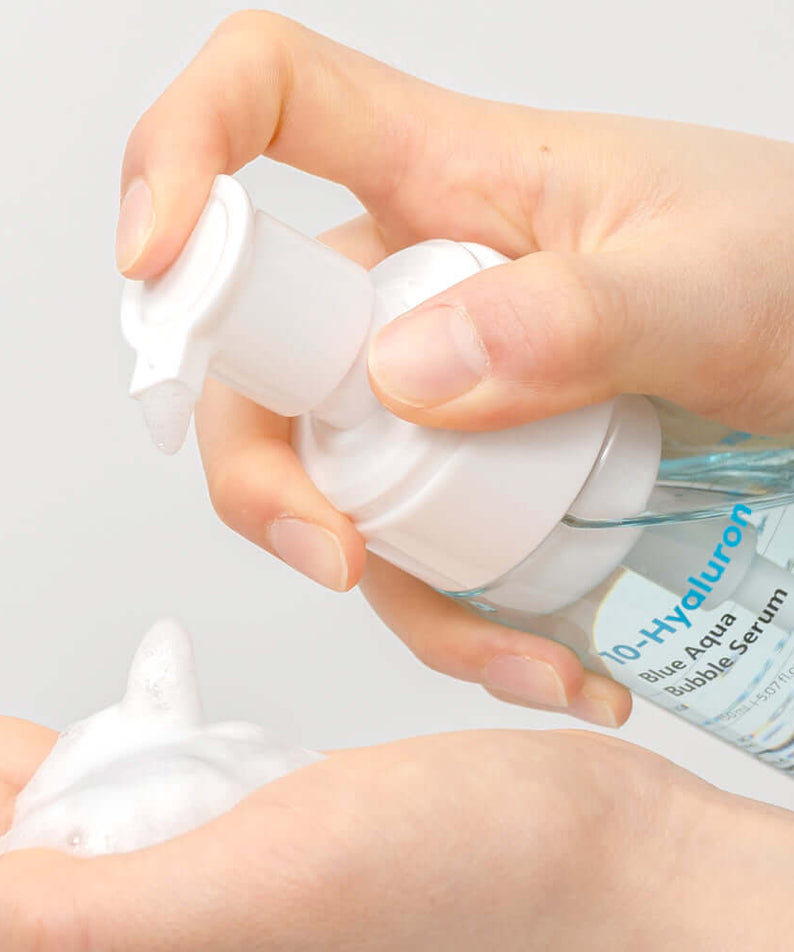 Hands using BARULAB 10-Hyaluronic Acid Blue Aqua Bubble Serum pump to dispense foam product
