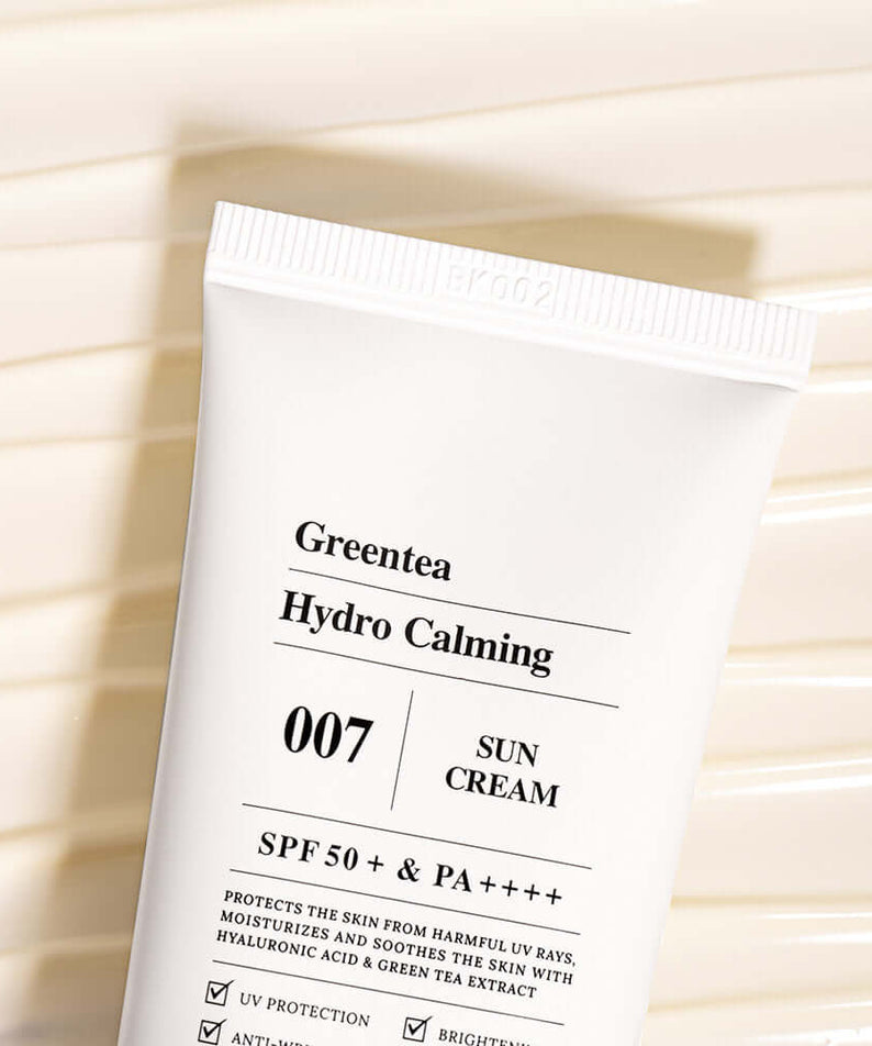 BARULAB Green Tea Hydro Calming Sun Cream tube showing SPF 50+ protection on a textured background.